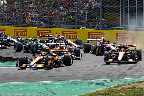 Italian Grand Prix 2024: McLaren driver Lando Norris of Britain, left, leads the field after the start